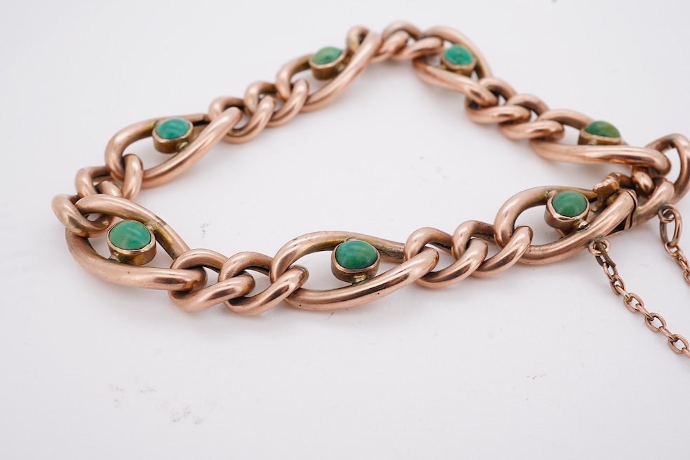 An early 20th century yellow metal (stamped 9c) and seven stone cabochon turquoise set curb link bracelet, 19cm, gross weight 14 grams. Condition - poor to fair